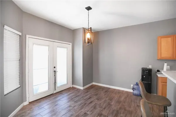 a view of a room with wooden floor furniture and windows