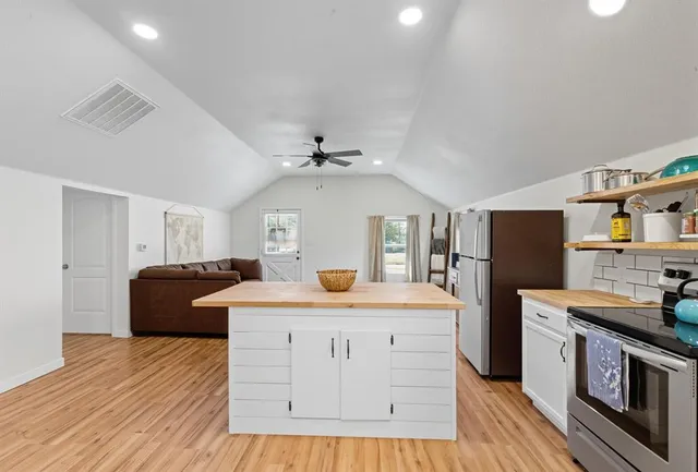 a kitchen with a stove a refrigerator and a sink