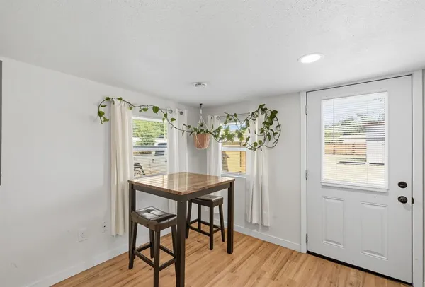 a view of a dining room with furniture and window