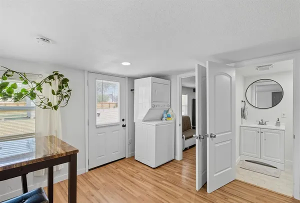 a view of an entryway with wooden floor and a workspace