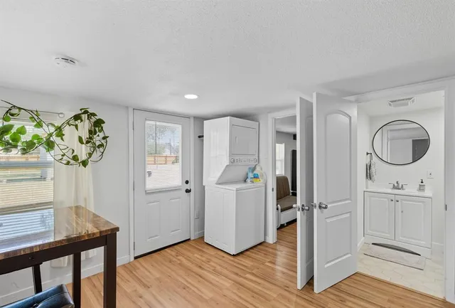 a view of an entryway with wooden floor and a workspace