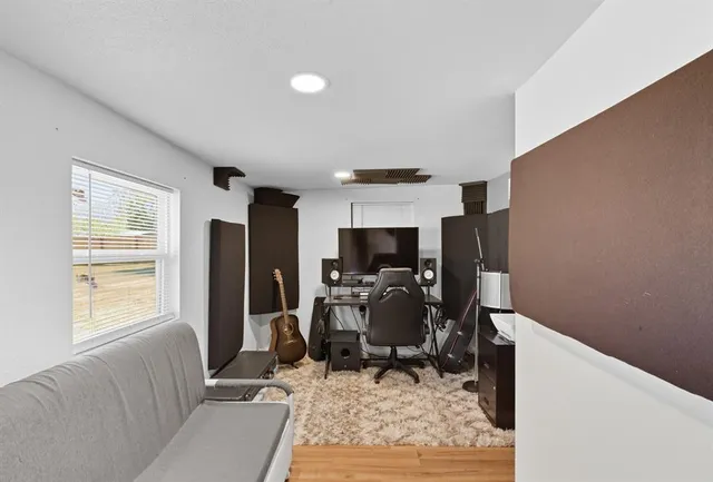 a view of a workspace with furniture and a window