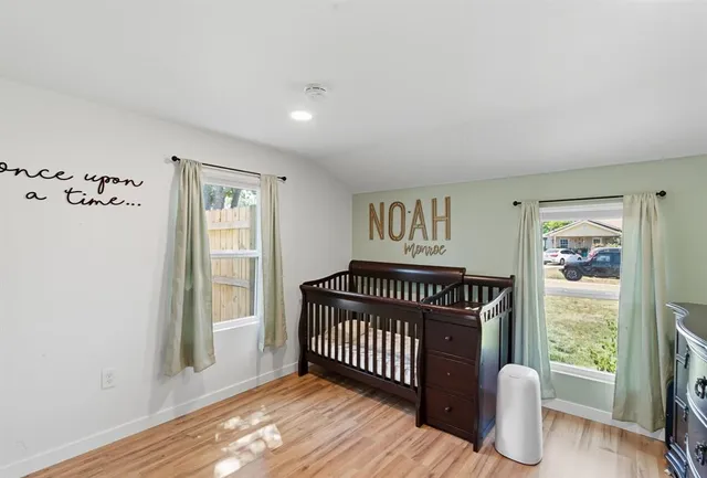 a view of a room with windows and wooden floor