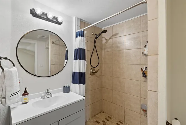 a bathroom with a sink a vanity and a mirror