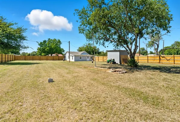 a view of swimming pool with a yard and trees