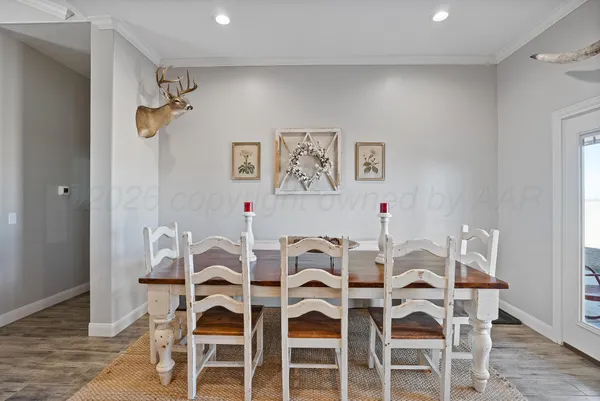 a kitchen with stainless steel appliances granite countertop a stove top oven a sink dishwasher and wooden cabinets with wooden floor