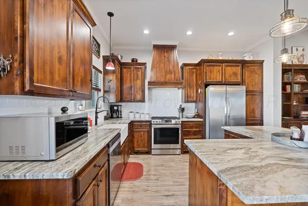 a kitchen with a sink stove top oven and cabinets