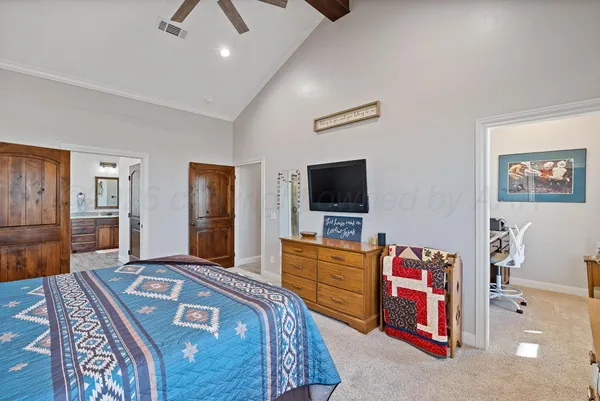 a bedroom with bed and a chandelier