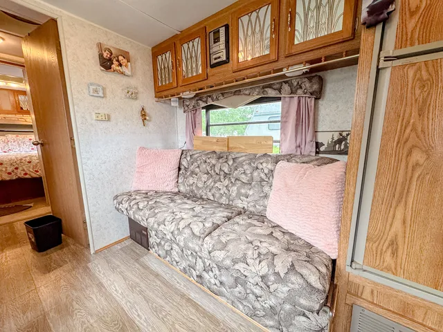 a bedroom with a bed next to a window