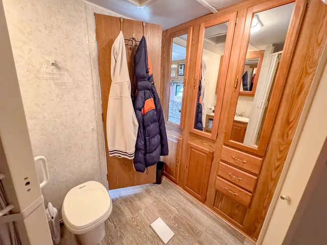 a bathroom with a toilet and a shower