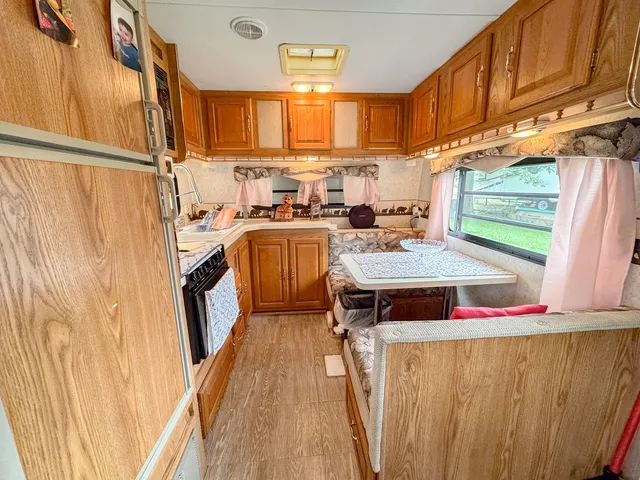 a kitchen with stainless steel appliances a stove a sink dishwasher and cabinets with wooden floor