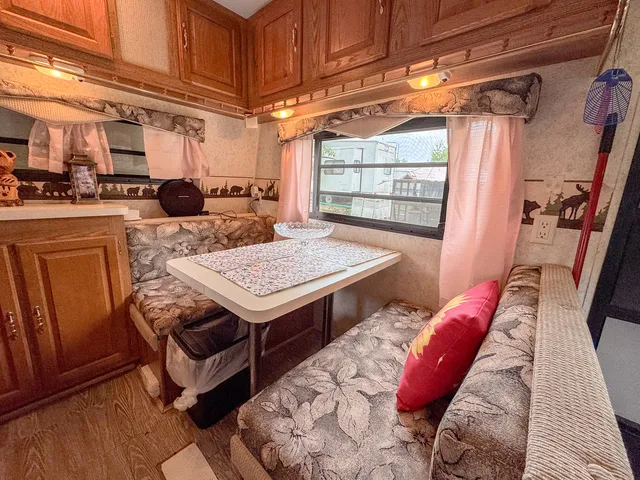 a view of a kitchen area with furniture and wooden floor