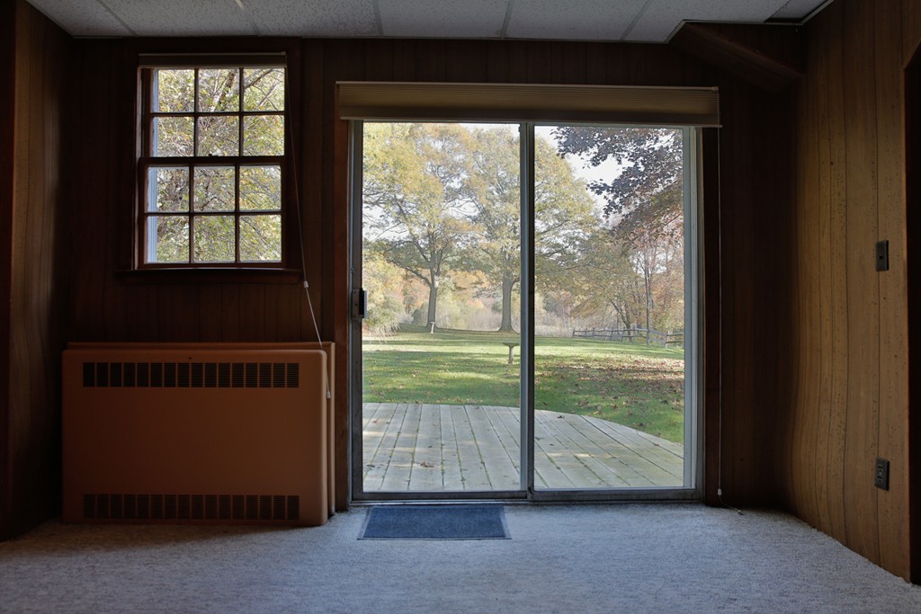 15 Leather Lane Beverly, MA 01915 - Photo 22 of 24 a view of an empty room with wooden floor and a floor to ceiling window