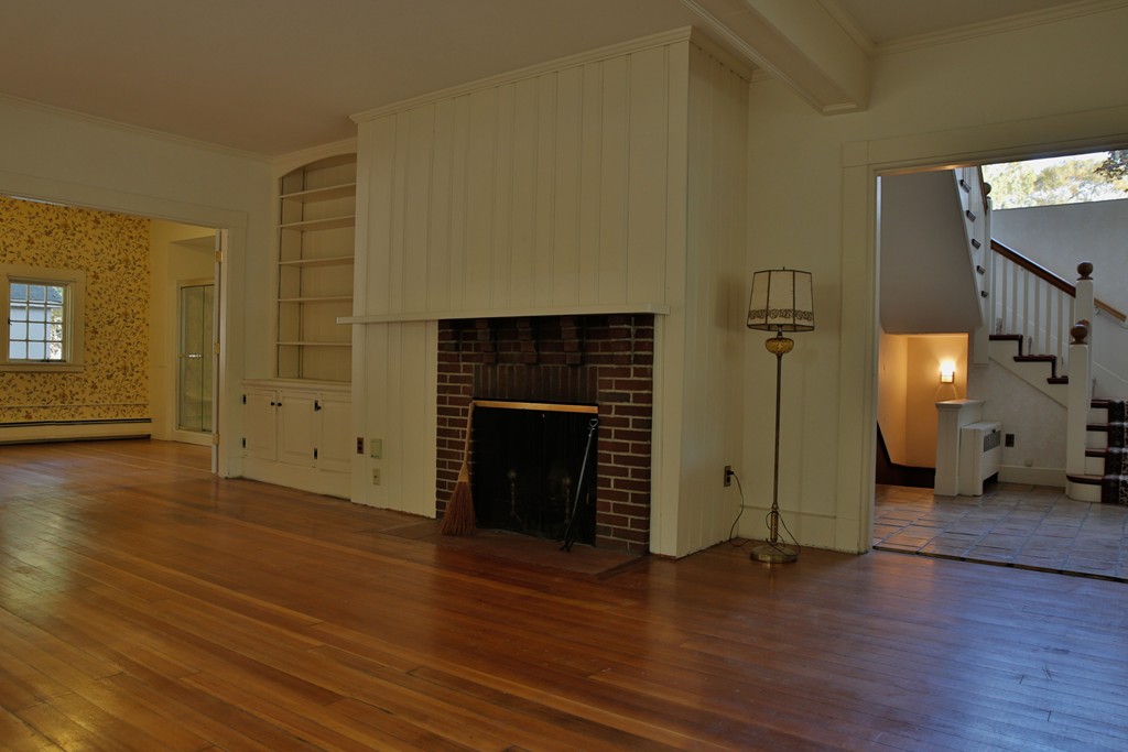 15 Leather Lane Beverly, MA 01915 - Photo 9 of 24 an empty room with wooden floor and fireplace