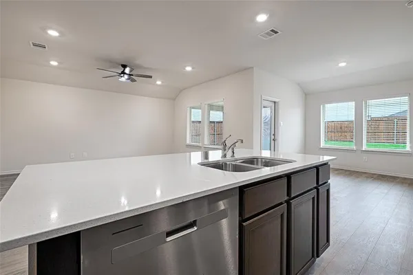 a kitchen with stainless steel appliances granite countertop a sink and a microwave
