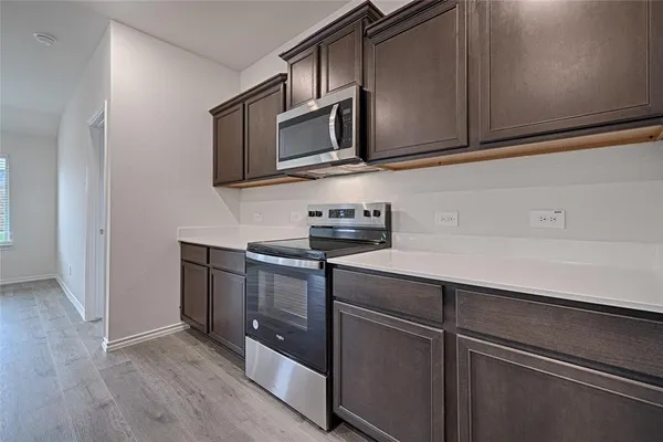 an empty room with chandelier fan