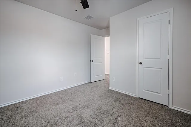 an empty room with closet area