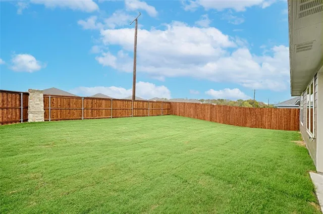 a view of a yard in front of a house with a yard