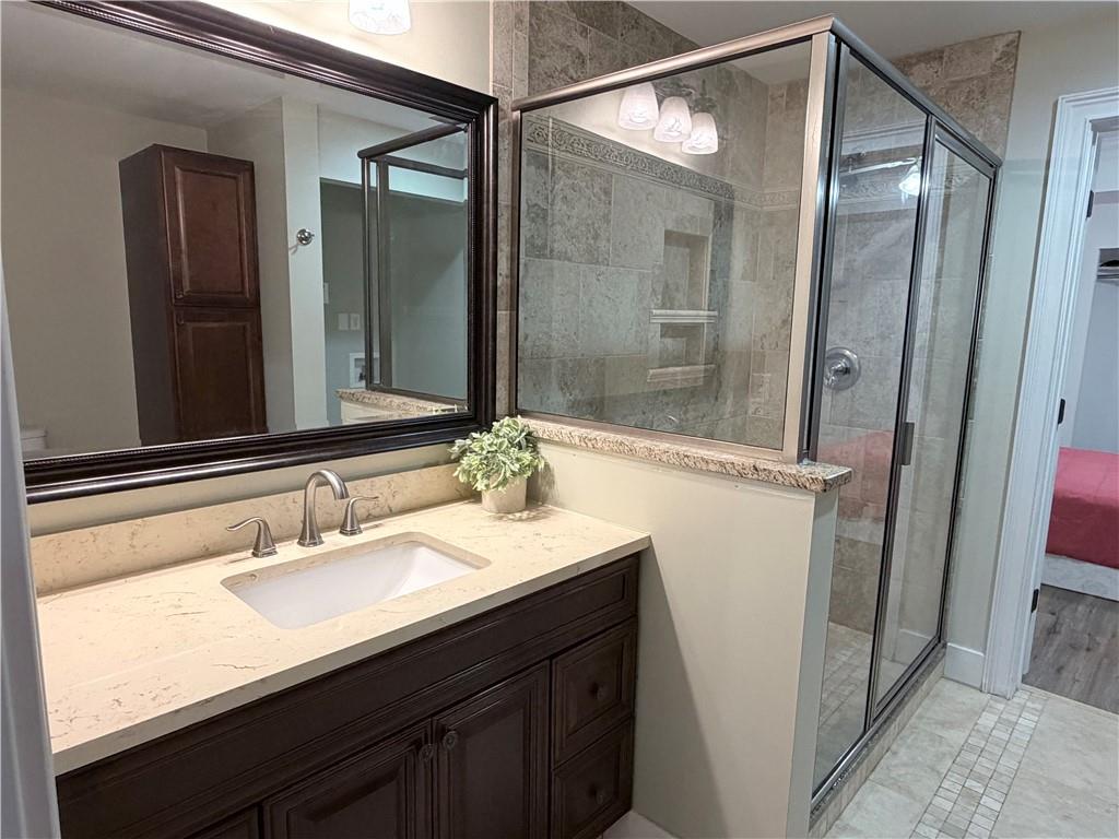 1600 Reddstone Cl Milton, GA 30004 - Photo 79 of 102 a bathroom with a sink vanity granite tub and shower