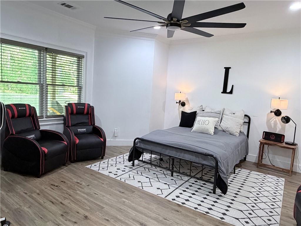 1600 Reddstone Cl Milton, GA 30004 - Photo 83 of 102 a bedroom with a bed a couch and a window