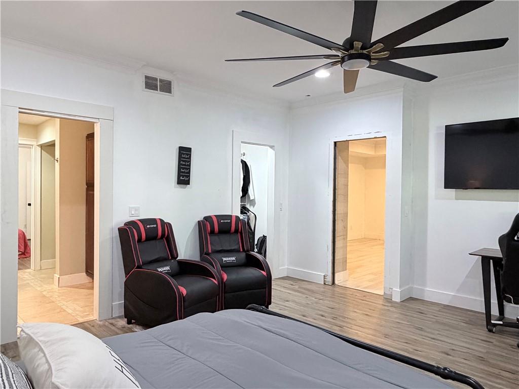 1600 Reddstone Cl Milton, GA 30004 - Photo 87 of 102 a bedroom with a bed and a flat screen tv
