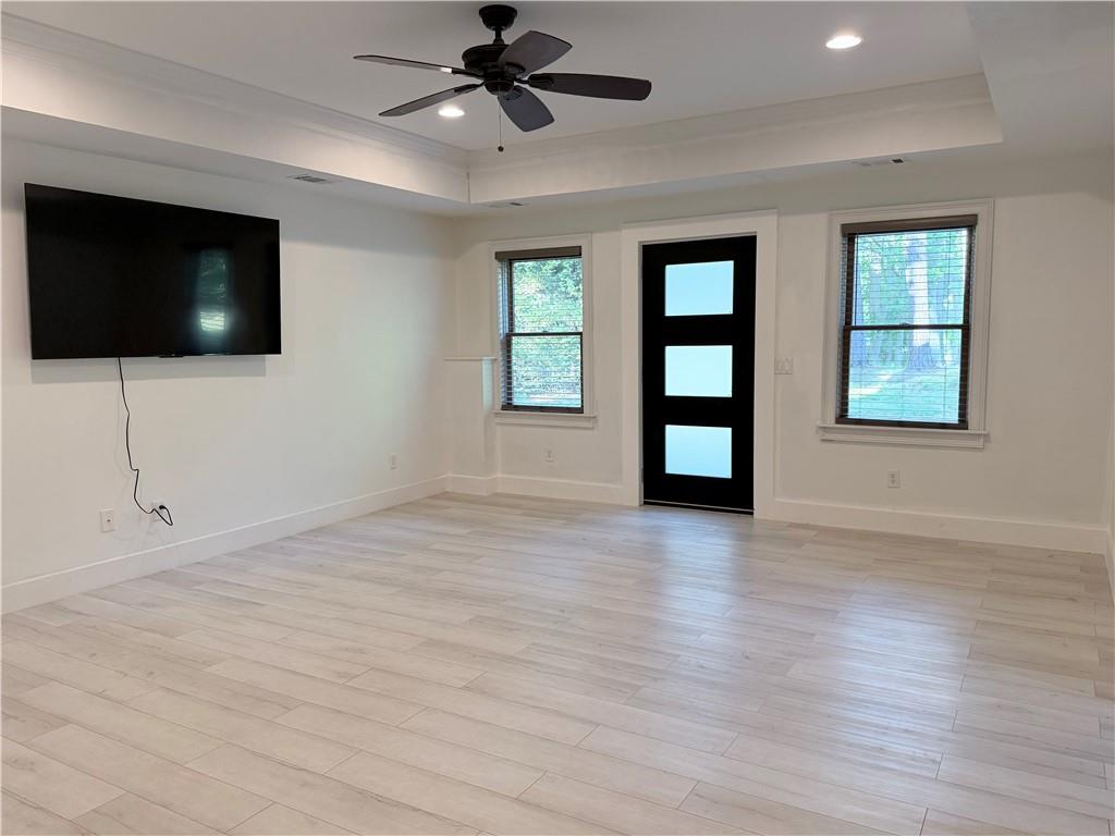 1600 Reddstone Cl Milton, GA 30004 - Photo 89 of 102 a view of an empty room with a flat screen tv and wooden floor