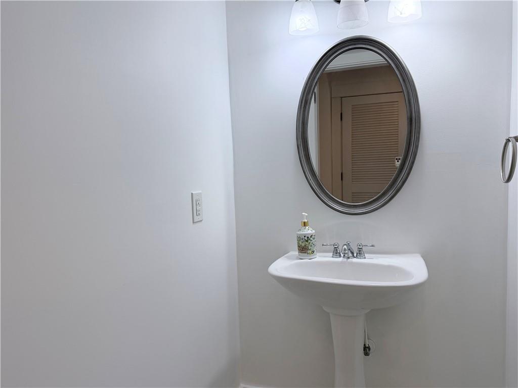 1600 Reddstone Cl Milton, GA 30004 - Photo 94 of 102 a bathroom with a sink and a mirror