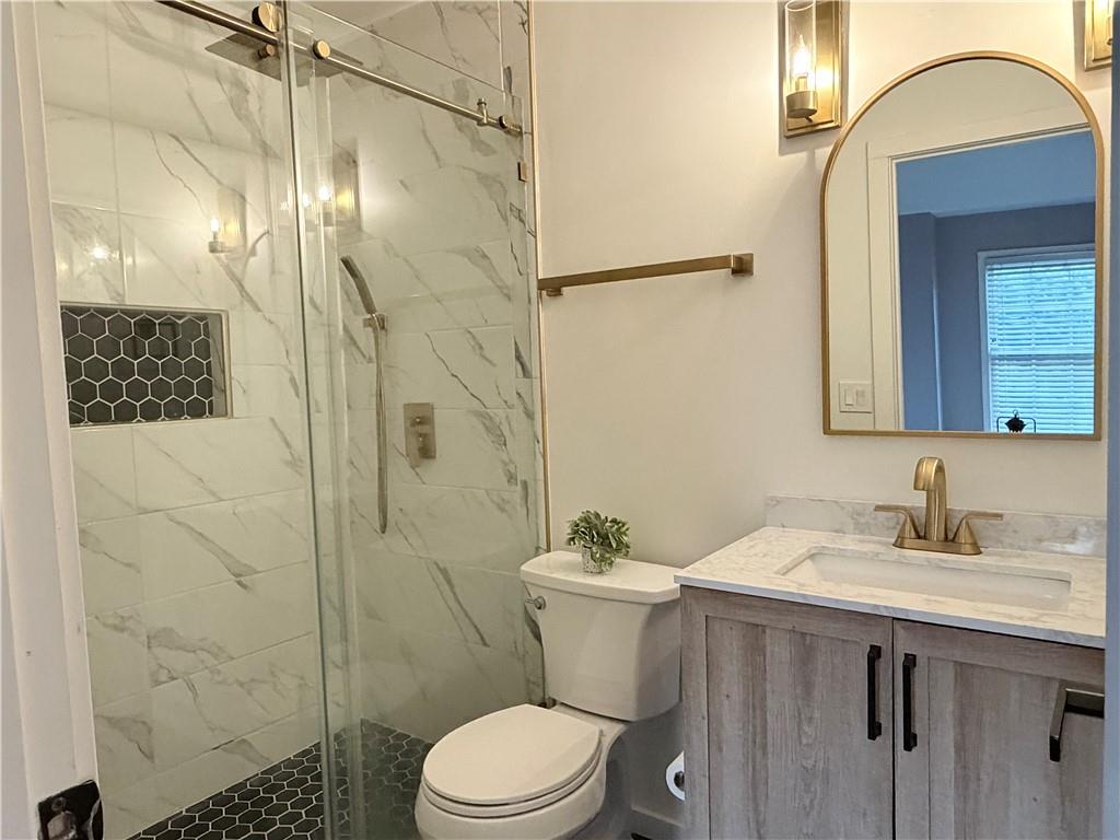 1600 Reddstone Cl Milton, GA 30004 - Photo 97 of 102 a bathroom with a sink a toilet and shower
