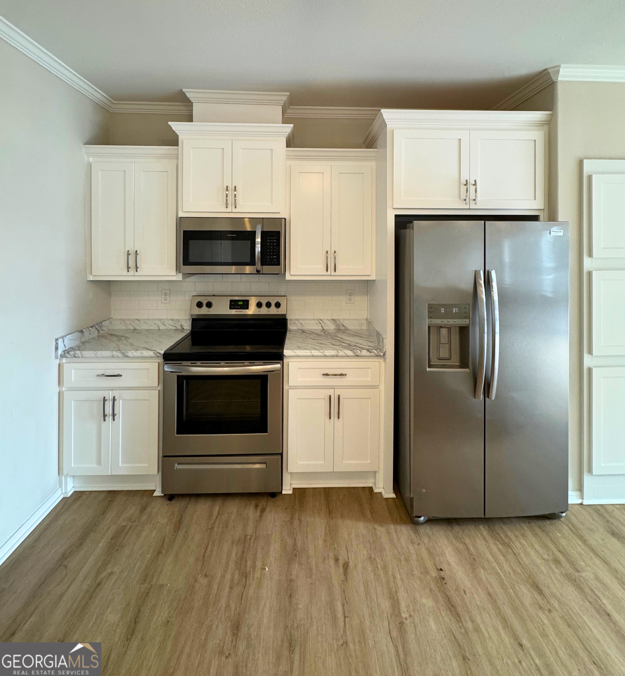 2554 Harrietts Bluff Road Woodbine, GA 31569 - Photo 15 of 35 a kitchen with a stove and a refrigerator