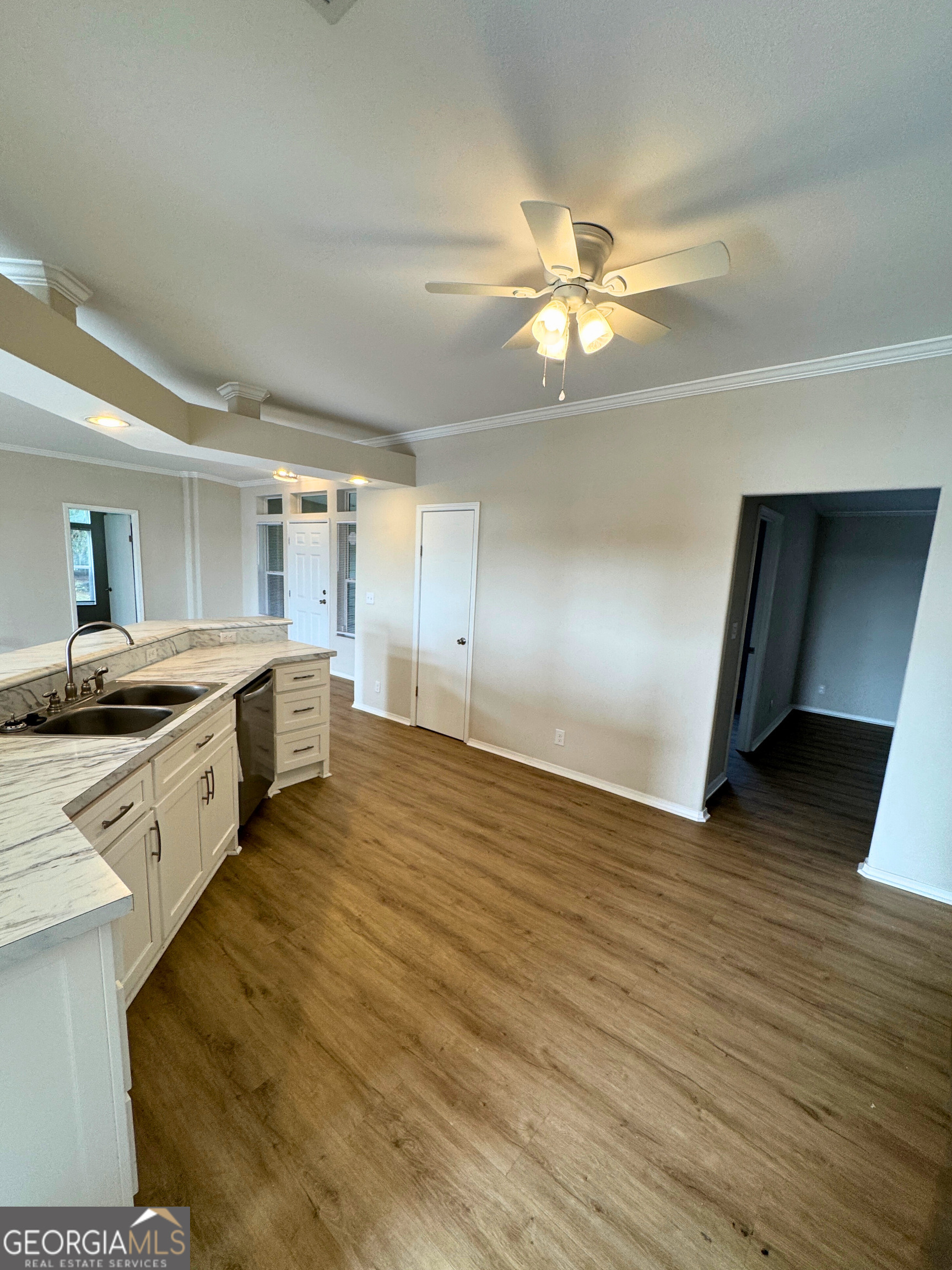 2554 Harrietts Bluff Road Woodbine, GA 31569 - Photo 16 of 35 a large kitchen with stainless steel appliances a large counter top a sink and a chandelier