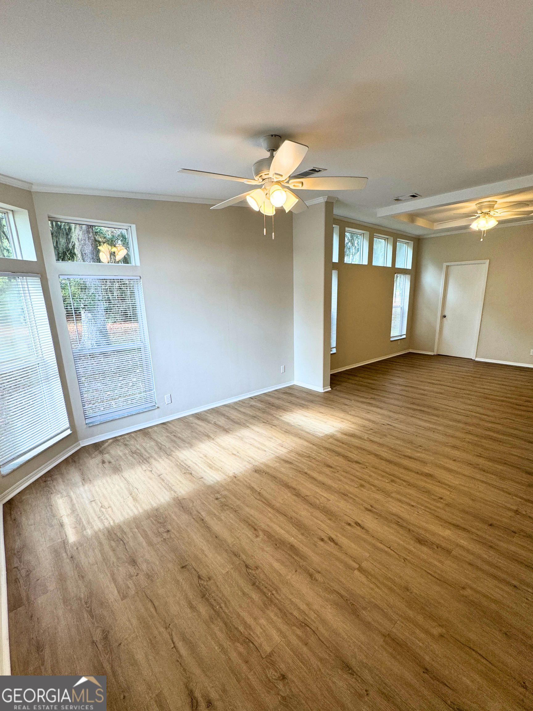 2554 Harrietts Bluff Road Woodbine, GA 31569 - Photo 17 of 35 wooden floor in an empty room with a window