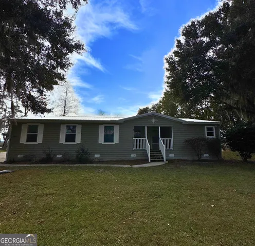a front view of house with yard and trees