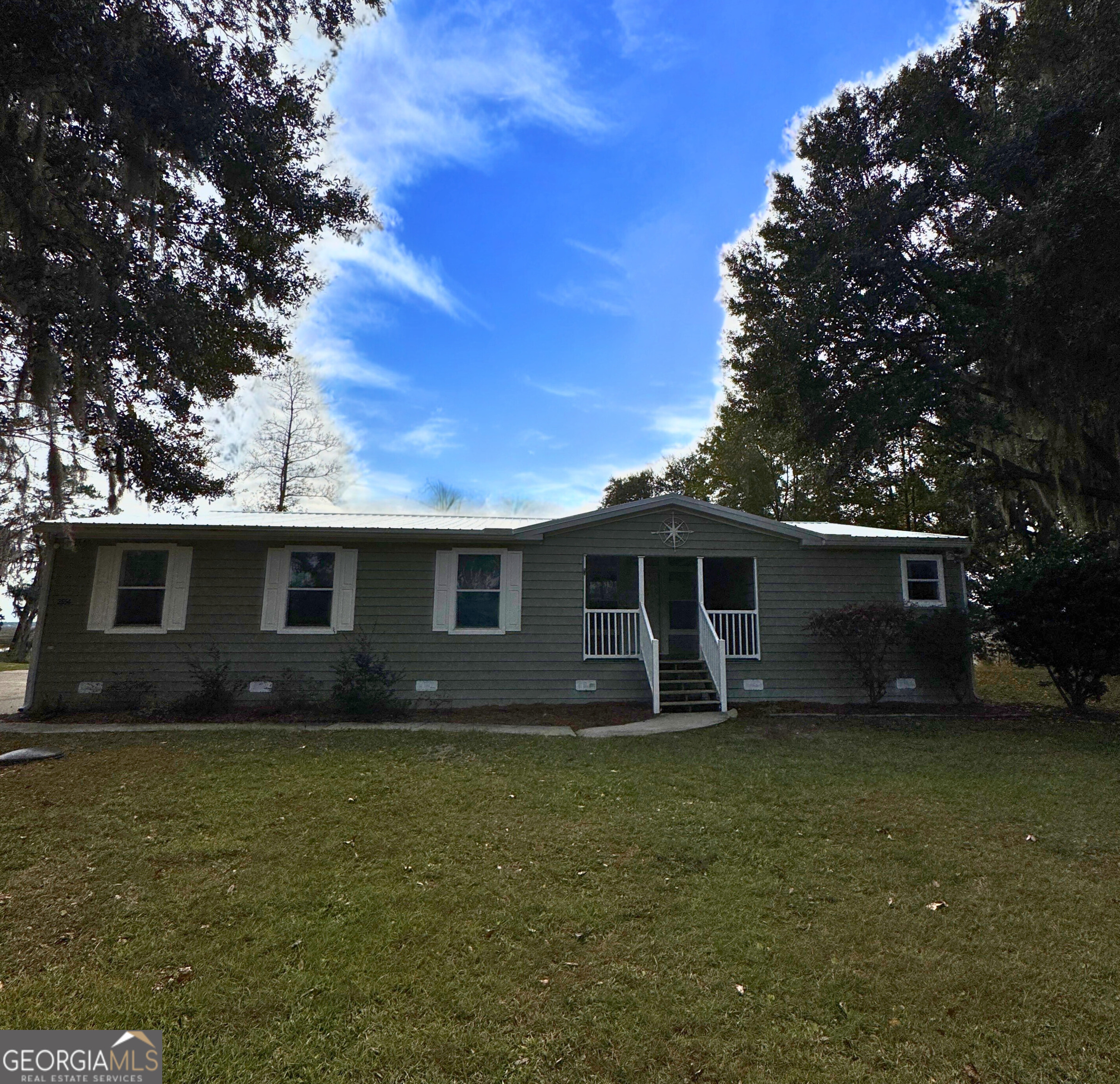 2554 Harrietts Bluff Road Woodbine, GA 31569 - Photo 2 of 35 a front view of house with yard and trees