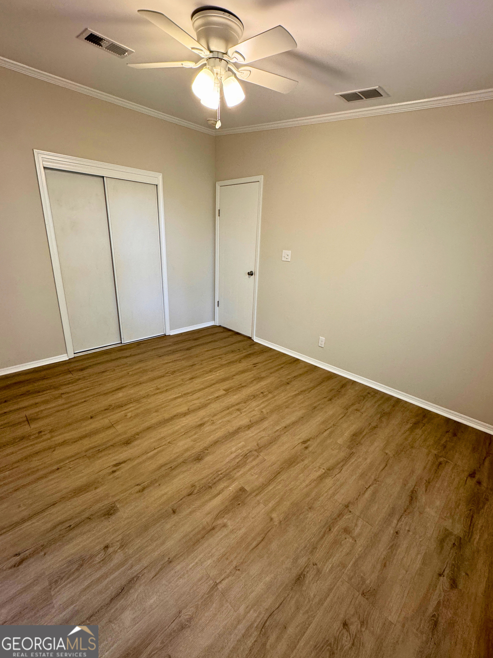 2554 Harrietts Bluff Road Woodbine, GA 31569 - Photo 23 of 35 wooden floor in an empty room