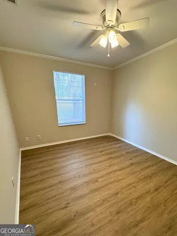 wooden floor in an empty room with a window