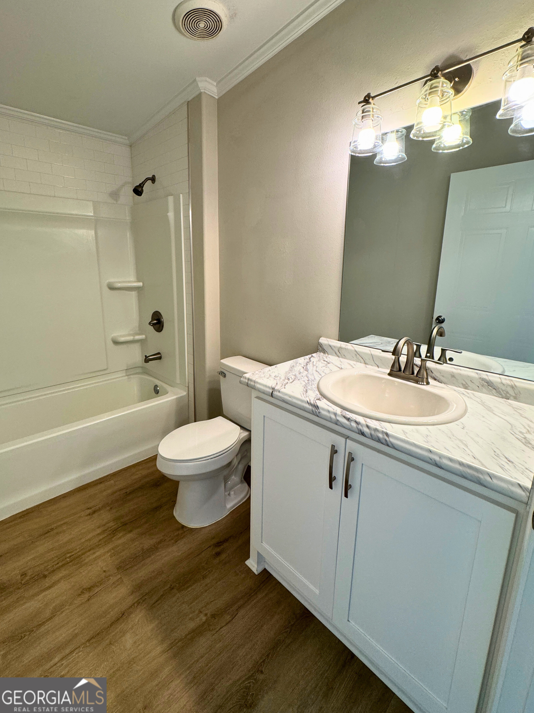 2554 Harrietts Bluff Road Woodbine, GA 31569 - Photo 25 of 35 a bathroom with a granite countertop sink toilet a large mirror a shower and a bathtub