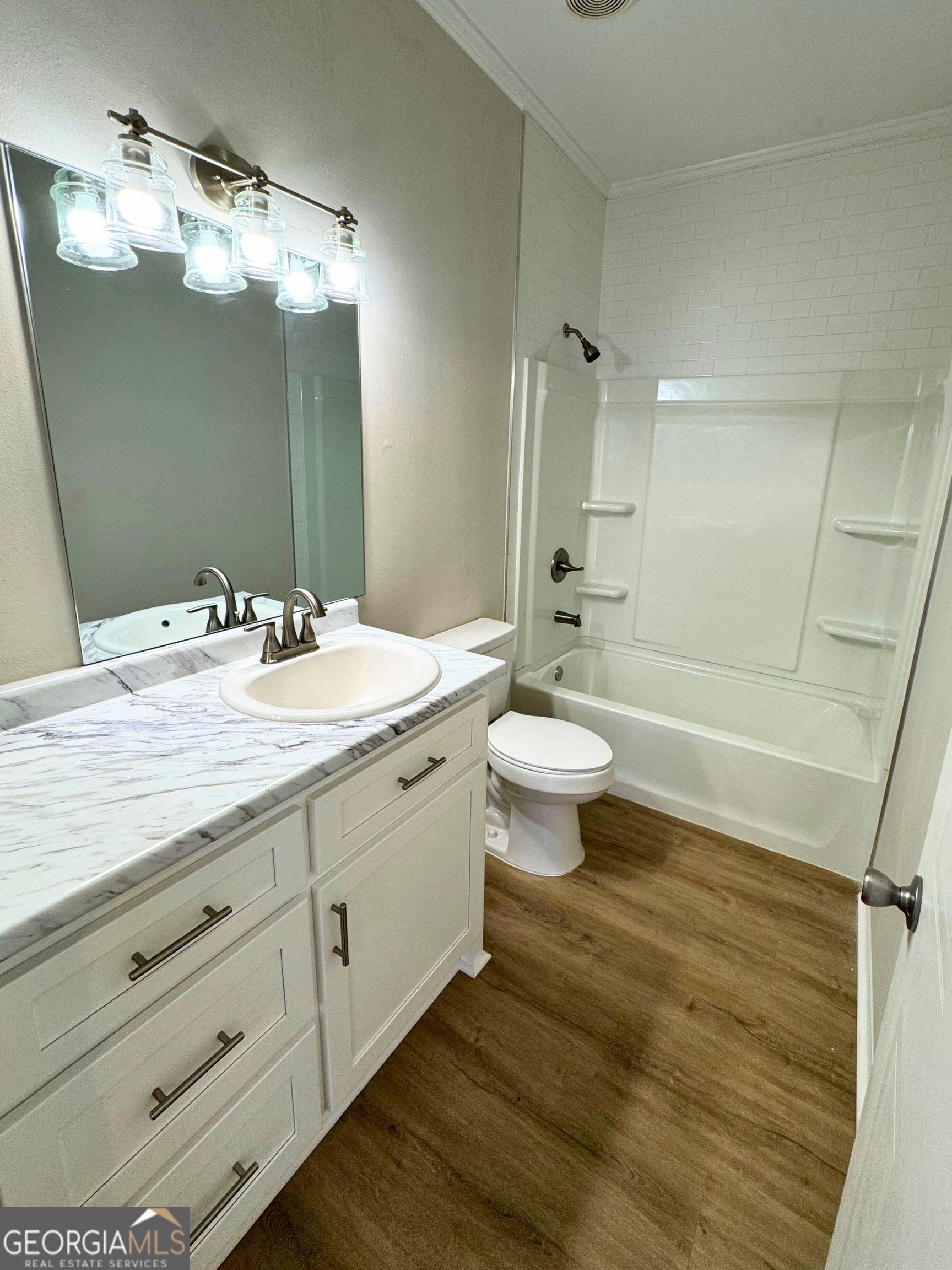 2554 Harrietts Bluff Road Woodbine, GA 31569 - Photo 26 of 35 a bathroom with a double vanity sink toilet and shower
