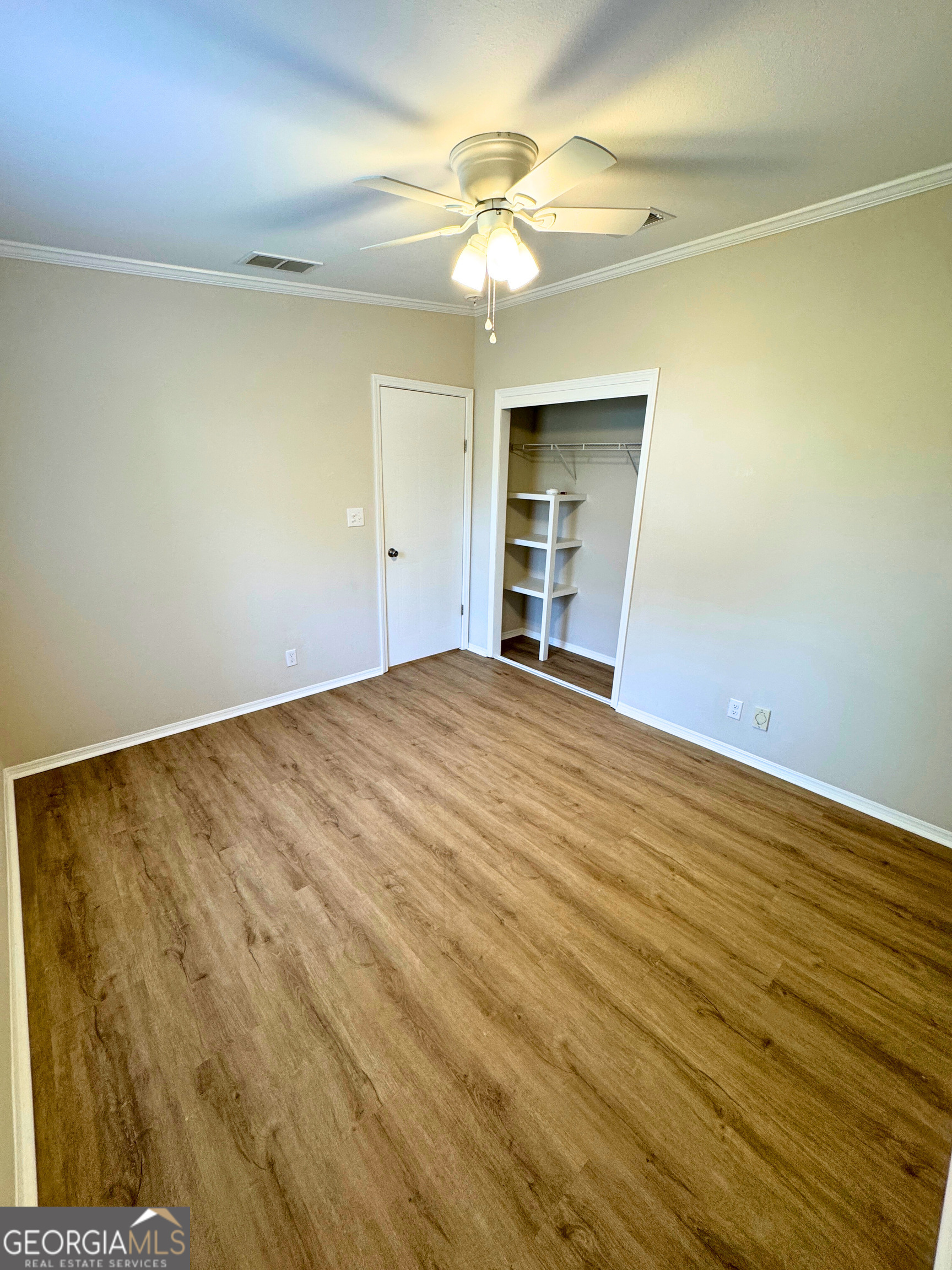 2554 Harrietts Bluff Road Woodbine, GA 31569 - Photo 27 of 35 wooden floor in an empty room with a window