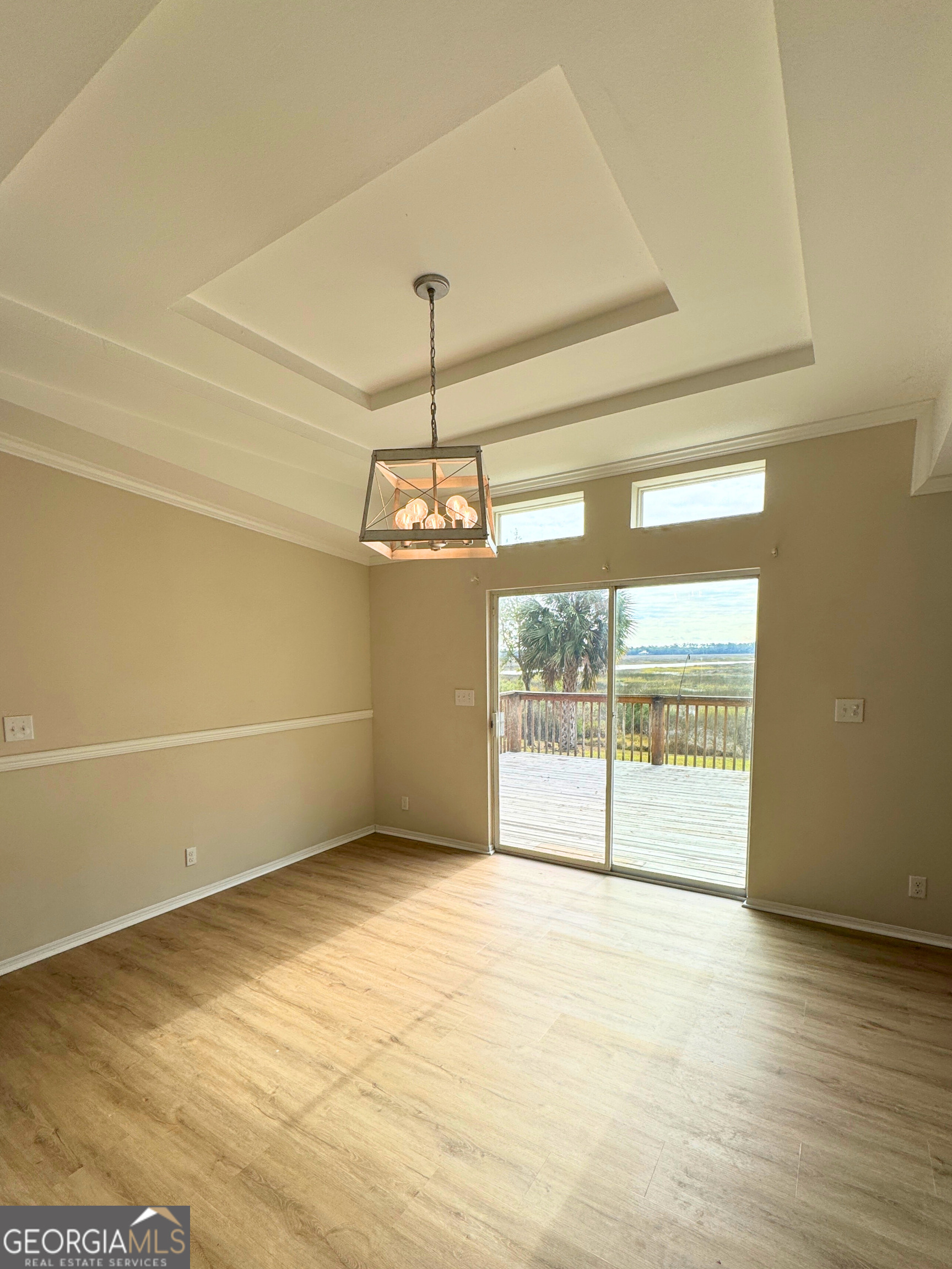 2554 Harrietts Bluff Road Woodbine, GA 31569 - Photo 6 of 35 a view of empty room with wooden floor and fan