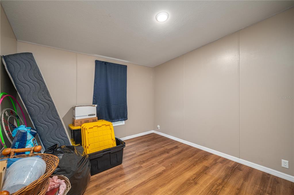 15079 Brahma Road Polk City, FL 33868 - Photo 22 of 40 a view of a room with wooden floor and furniture