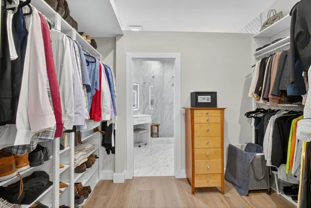 a bathroom with a granite countertop sink a mirror and a shower