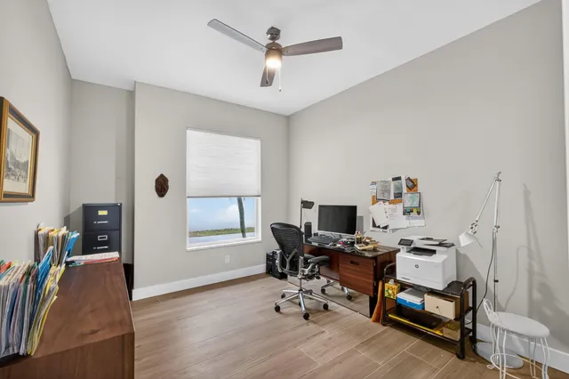 a kitchen with white cabinets and sink