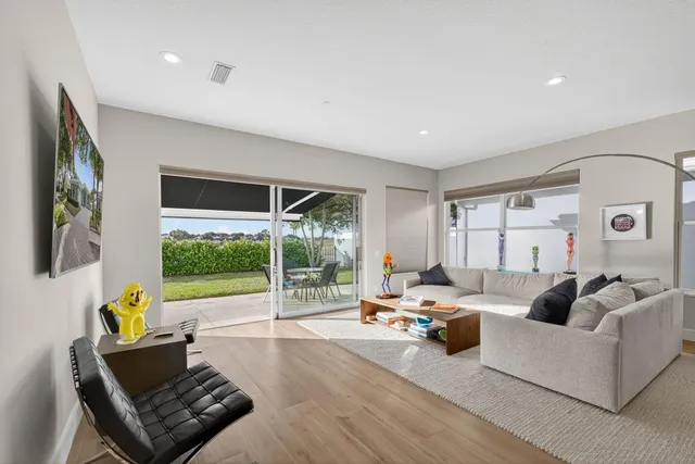 a view of a backyard with table and chairs under an umbrella