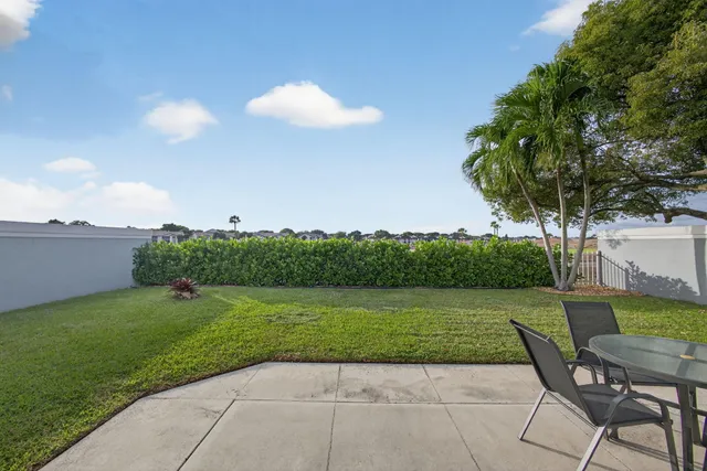 a front view of a house with a garden and patio
