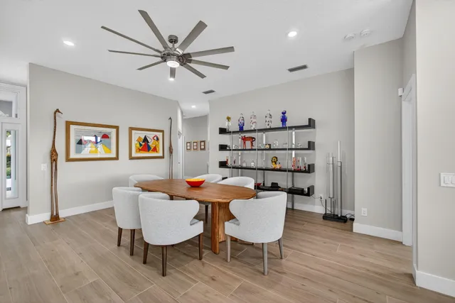 a view of a dining room with furniture and wooden floor
