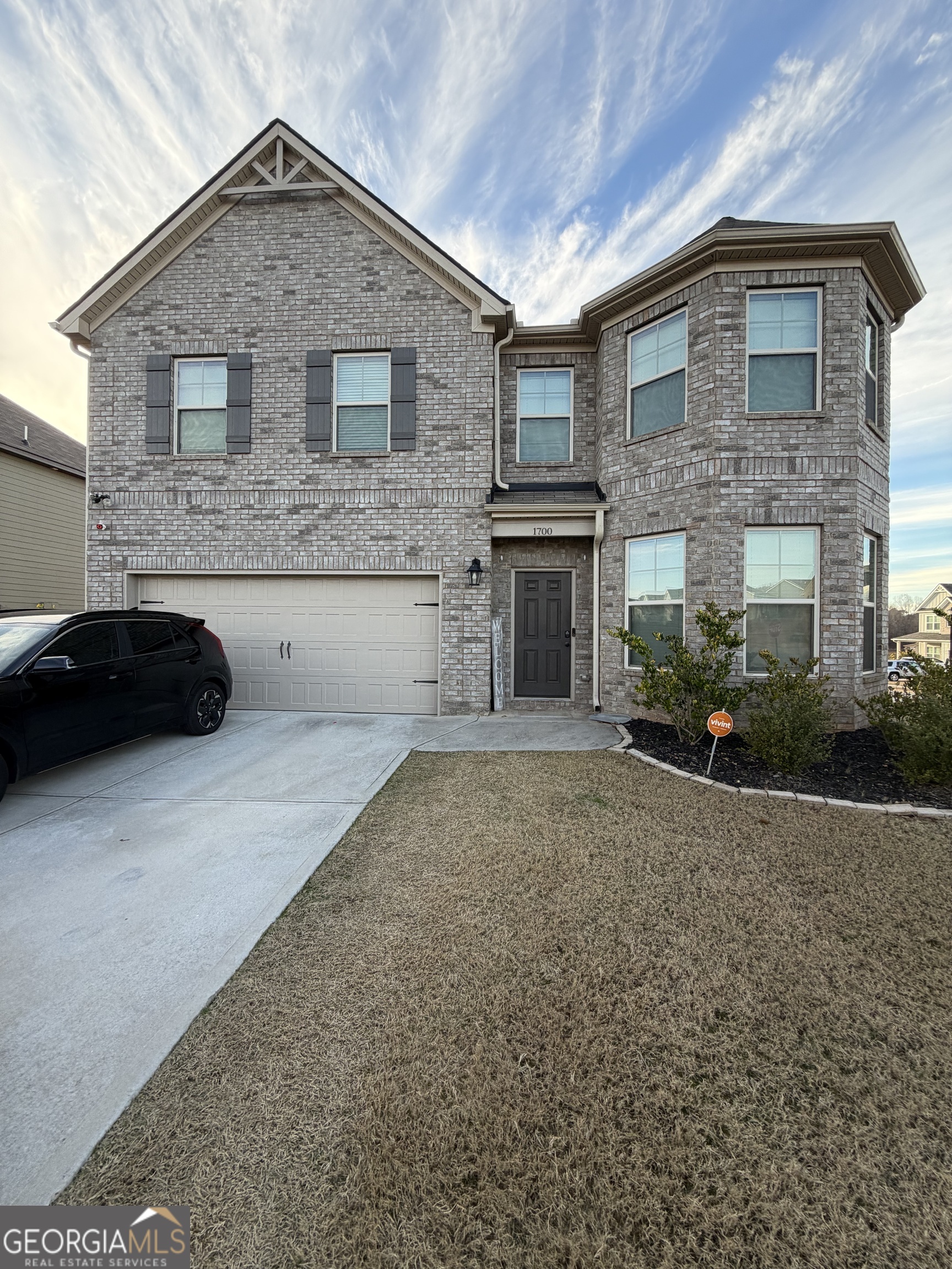 a front view of a house with a yard