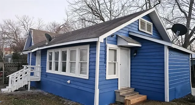 a view of wooden house with a large window