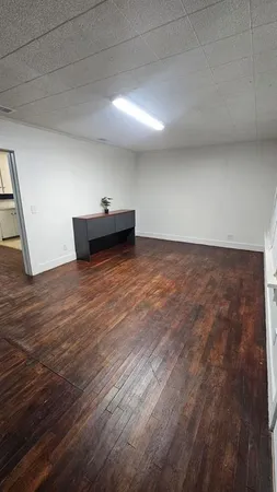 a view of a room with wooden floor
