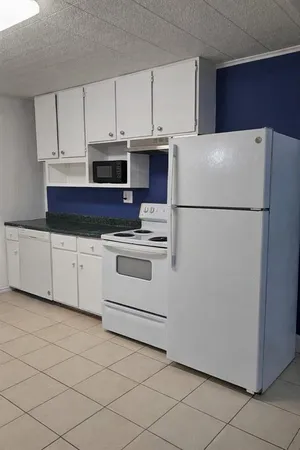 a white refrigerator freezer sitting in a kitchen