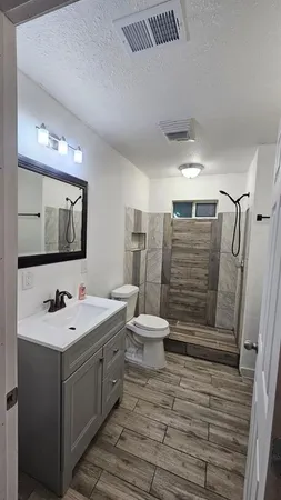 a bathroom with a sink toilet and shower